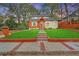 Charming exterior featuring a manicured lawn, stone walkway, and craftsman-style details at 3637 Elm St, Atlanta, GA 30354