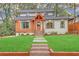 Inviting home exterior with a well-kept lawn, wood accents and a welcoming entrance at 3637 Elm St, Atlanta, GA 30354