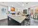 Spacious kitchen featuring a large island, granite countertops, modern appliances, and stylish pendant lighting at 3637 Elm St, Atlanta, GA 30354