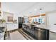 Beautiful open kitchen with stainless steel appliances, sleek black cabinets, and granite countertops, perfect for entertaining at 3637 Elm St, Atlanta, GA 30354