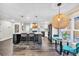 Open-concept kitchen flowing into the living area, featuring dark wood floors and a large center island at 3637 Elm St, Atlanta, GA 30354
