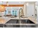Modern kitchen with a large island, stainless steel sink, and stylish lighting at 3637 Elm St, Atlanta, GA 30354
