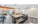 Open kitchen with an island with a sink and seating, stainless steel appliances, and a seamless flow to the living room at 3637 Elm St, Atlanta, GA 30354