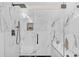 Shower features marble tiles, glass doors, a built-in niche, and a sleek showerhead and faucet at 3637 Elm St, Atlanta, GA 30354