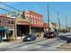 Street scene with various buildings, cars parked along the road, and utility poles with wires at 3637 Elm St, Atlanta, GA 30354