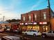 Exterior view of a theatre at dusk with storefronts, cars, and streetlights at 3637 Elm St, Atlanta, GA 30354