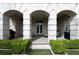 Covered back porch with 3 stone archways, furniture and manicured hedges at 2440 Peachtree Nw Rd # 1, Atlanta, GA 30305