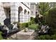 Beautiful backyard featuring manicured landscaping, garden benches, and unique sculpture for outdoor enjoyment at 2440 Peachtree Nw Rd # 1, Atlanta, GA 30305