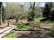 Inviting backyard with mature trees, stone bridge, and a manicured lawn, perfect for relaxation and outdoor activities at 2440 Peachtree Nw Rd # 1, Atlanta, GA 30305
