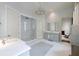 Bright bathroom featuring dual vanities, a glass-enclosed shower, and elegant fixtures at 2440 Peachtree Nw Rd # 1, Atlanta, GA 30305