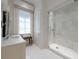 Bathroom featuring marble countertops, a glass shower, and white tile at 2440 Peachtree Nw Rd # 1, Atlanta, GA 30305