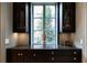 Custom built-in cabinetry under window with statuette and polished countertops at 2440 Peachtree Nw Rd # 1, Atlanta, GA 30305
