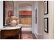 Elegant hallway with a marble-topped console table, showcasing art and decorative vases at 2440 Peachtree Nw Rd # 1, Atlanta, GA 30305