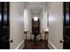 Hallway featuring dark hardwood floors, a large mirror, and sculptural art at 2440 Peachtree Nw Rd # 1, Atlanta, GA 30305