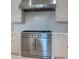 Stainless steel commercial range with custom marble backsplash and countertop at 2440 Peachtree Nw Rd # 1, Atlanta, GA 30305