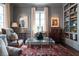 Inviting living room featuring gray walls, built-in shelving, and a clear coffee table on an ornate red rug at 2440 Peachtree Nw Rd # 1, Atlanta, GA 30305