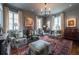 Elegant living room features a stylish chandelier, multiple seating areas, and beautiful hardwood floors at 2440 Peachtree Nw Rd # 1, Atlanta, GA 30305