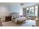 Serene primary bedroom with decorative wall molding, sitting area, and large windows at 2440 Peachtree Nw Rd # 1, Atlanta, GA 30305