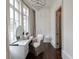 Elegant vanity area with a large window, chandelier, built-in cabinets, and wood flooring at 2440 Peachtree Nw Rd # 1, Atlanta, GA 30305