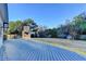 A spacious wood deck overlooks the grassy backyard with mature trees and a stone fireplace at 3550 Lakeheath Dr, Cumming, GA 30041