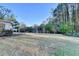 Expansive backyard featuring a well-maintained lawn and mature trees at 3550 Lakeheath Dr, Cumming, GA 30041