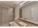This bathroom offers a tiled shower with a glass door and a vanity with a granite countertop at 3550 Lakeheath Dr, Cumming, GA 30041