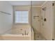 Bathroom featuring a soaking tub and glass shower at 3550 Lakeheath Dr, Cumming, GA 30041