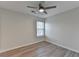 This well-lit bedroom features wood-style flooring, a ceiling fan, and a window at 3550 Lakeheath Dr, Cumming, GA 30041
