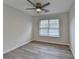 This bedroom includes a window, wood-style flooring, and a ceiling fan at 3550 Lakeheath Dr, Cumming, GA 30041