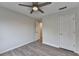 This bedroom features a ceiling fan, wood-style flooring, and a neutral color palette at 3550 Lakeheath Dr, Cumming, GA 30041