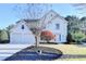 Charming two-story home featuring a well-manicured lawn and a three-car garage at 3550 Lakeheath Dr, Cumming, GA 30041