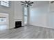 Spacious living room with high ceilings, a fireplace, wood-look floors and large windows for lots of light at 3550 Lakeheath Dr, Cumming, GA 30041