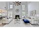 Spacious living room with high ceilings, a cozy fireplace, and lots of natural light at 3550 Lakeheath Dr, Cumming, GA 30041