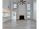 Open living room with high ceilings, a fireplace, and wood-look flooring, perfect for entertaining at 3550 Lakeheath Dr, Cumming, GA 30041