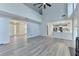 Open-concept living room with wood-look flooring, a fireplace, and views into other rooms at 3550 Lakeheath Dr, Cumming, GA 30041
