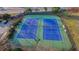 Aerial view of well-maintained community tennis courts with players in action at 3550 Lakeheath Dr, Cumming, GA 30041