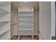 A spacious walk-in closet features built-in shelving and wood-style flooring for organized storage at 3550 Lakeheath Dr, Cumming, GA 30041