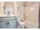 Clean bathroom featuring a shower-tub combo, a modern vanity, and ample storage at 6187 Kelly Carlin Way, Norcross, GA 30071