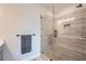 Walk-in shower with neutral colored tile and glass door at 6187 Kelly Carlin Way, Norcross, GA 30071