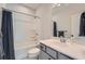 This bathroom features a shower over tub combo, and vanity with storage at 6187 Kelly Carlin Way, Norcross, GA 30071
