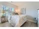 Charming bedroom with a white metal bed frame, soft linens, and natural light from two windows at 6187 Kelly Carlin Way, Norcross, GA 30071
