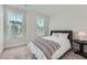 Comfortable bedroom featuring a bed, side table, and bright window at 6187 Kelly Carlin Way, Norcross, GA 30071