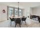 Inviting dining room with a round table, contemporary chandelier, large windows, and stylish accents at 6187 Kelly Carlin Way, Norcross, GA 30071