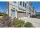 Attractive townhome exhibiting brick and siding, a well-manicured lawn, attached garage, and a welcoming entrance at 6187 Kelly Carlin Way, Norcross, GA 30071