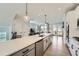 Modern kitchen features an island, stainless steel appliances, and opens to the living room at 6187 Kelly Carlin Way, Norcross, GA 30071