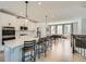 Bright, open-concept kitchen featuring a large island, stainless steel appliances, and seamless flow into the dining area at 6187 Kelly Carlin Way, Norcross, GA 30071