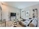 Cozy living room with a plush sectional sofa, stylish decor, and a flat-screen TV for entertainment at 6187 Kelly Carlin Way, Norcross, GA 30071