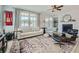 Elegant living room with hardwood floors, large windows, designer furnishings, and a cozy fireplace at 6187 Kelly Carlin Way, Norcross, GA 30071