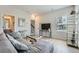 Inviting living room featuring a comfortable gray sectional, decorous mirror, and sleek entertainment center at 6187 Kelly Carlin Way, Norcross, GA 30071