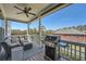 Relaxing covered patio with comfortable seating, a grill, and a ceiling fan at 6187 Kelly Carlin Way, Norcross, GA 30071